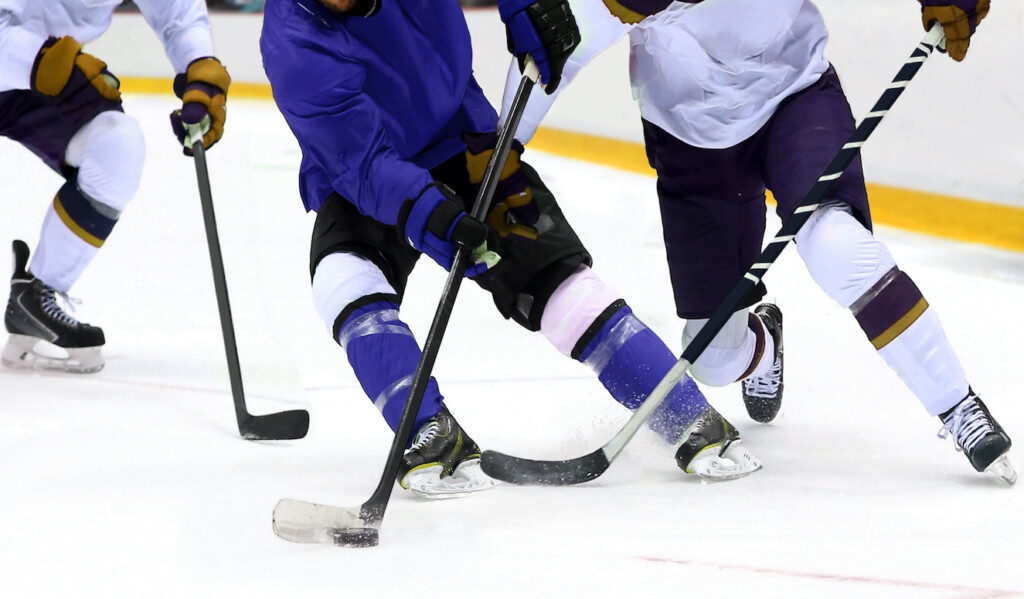Ice,Hockey,Player,Dribbling,Puck,On,Rink